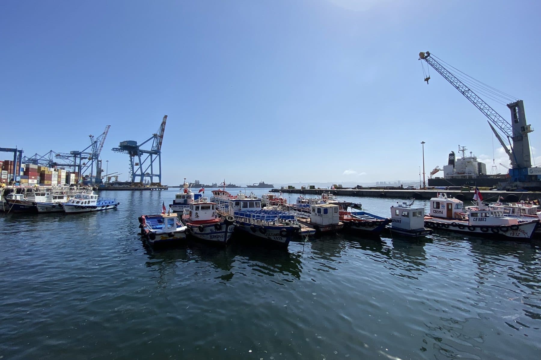 Container gantry cranes and moored fishing boats at the port of Valparaíso, Chile